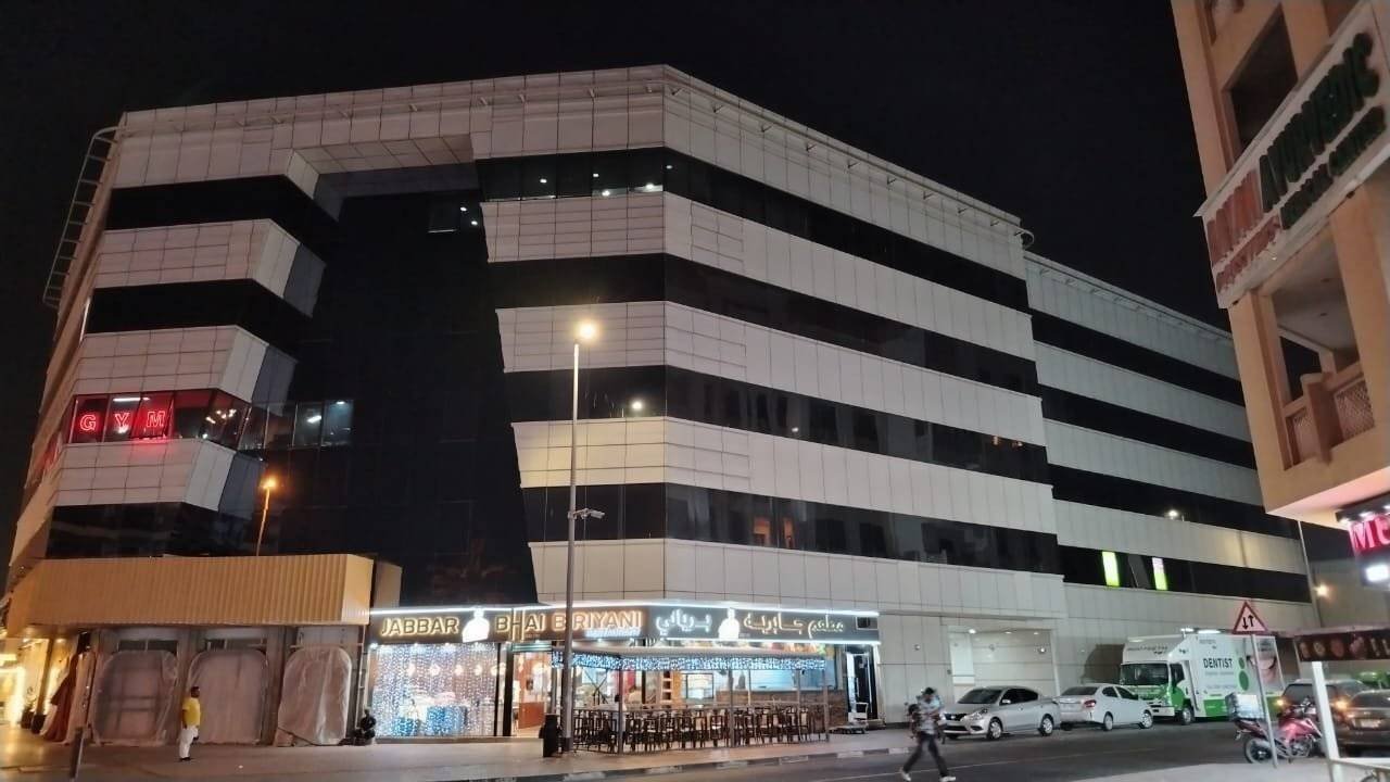 a building with a sign on the side for homex furniture store